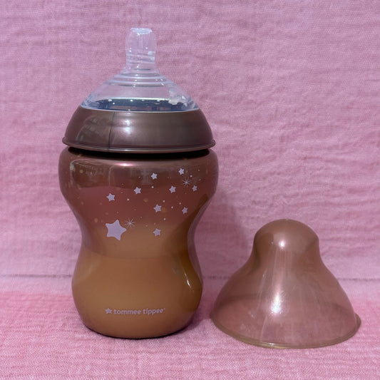 Bronze baby bottle with star pattern and cap