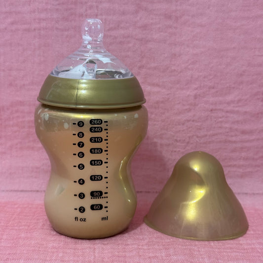 Baby bottle with gold cap and nipple