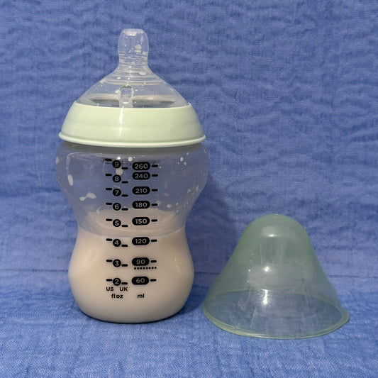 Baby bottle with nipple in pale green