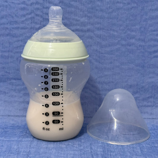 Baby bottle with nipple in pale green