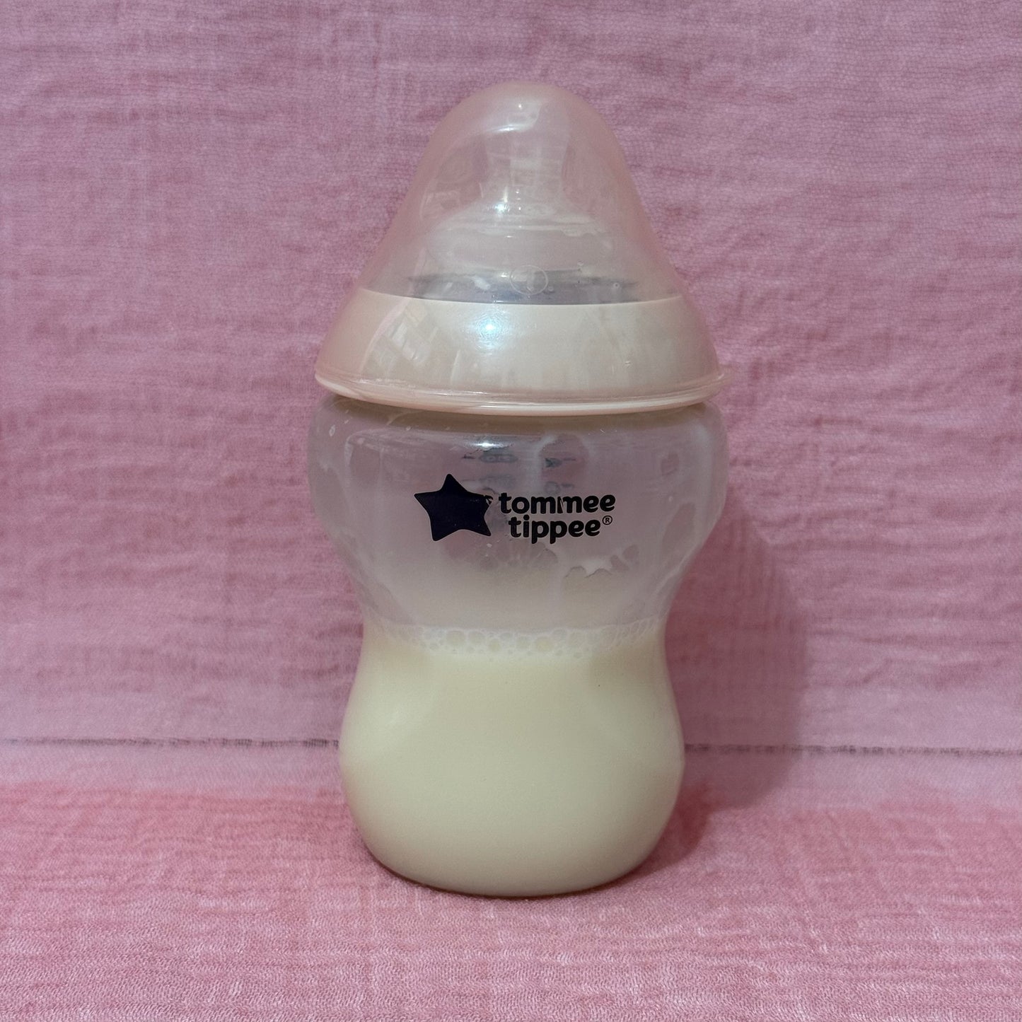 Baby bottle with Tommee Tippee logo in pink