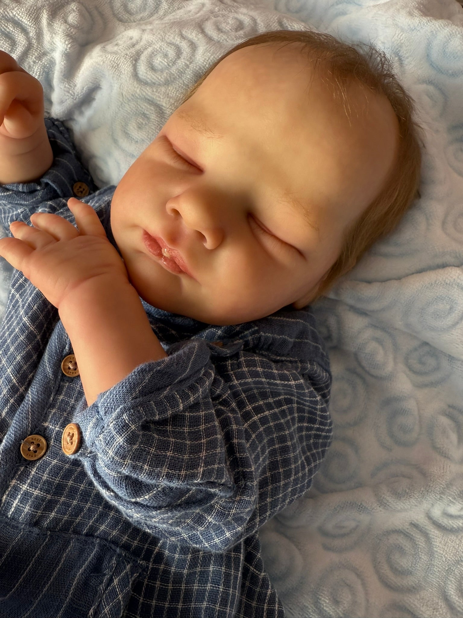 Baby sleeping on a textured blanket