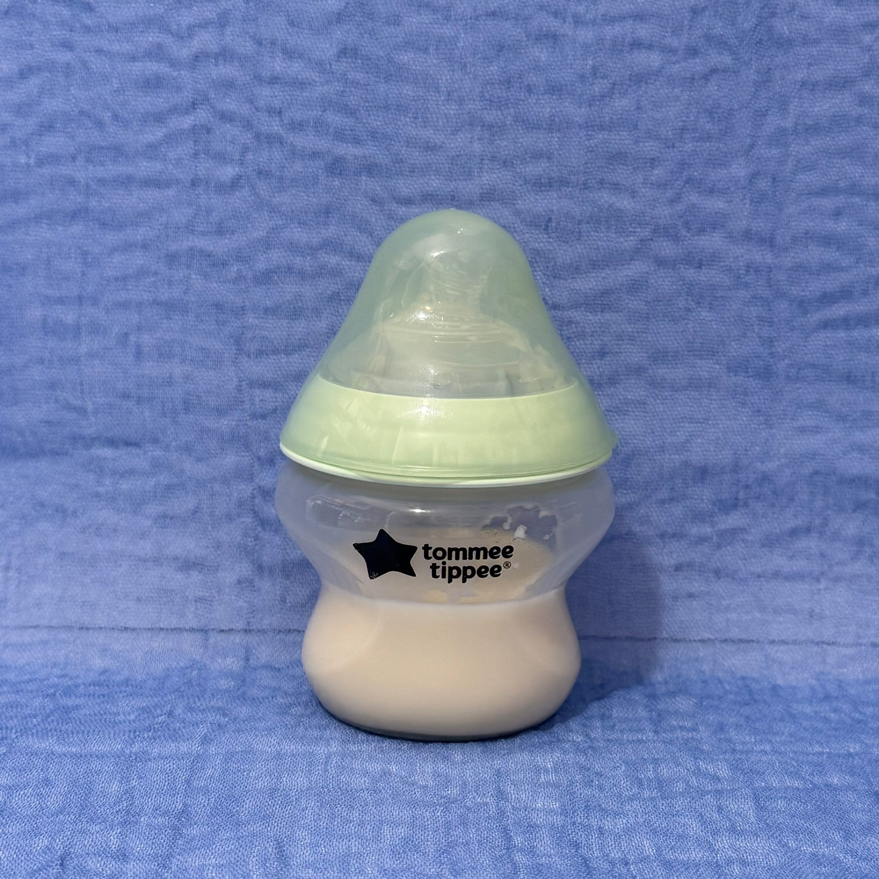 Baby bottle with green cap