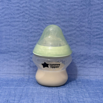 Baby bottle with green cap