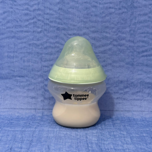 Baby bottle with green cap