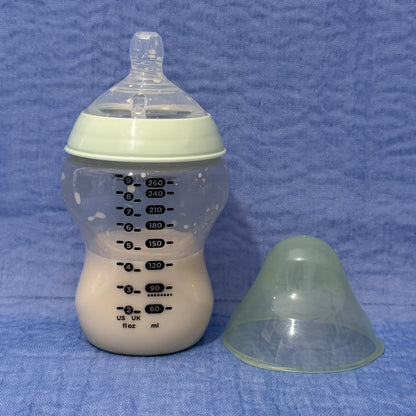 Baby bottle with nipple in pale green
