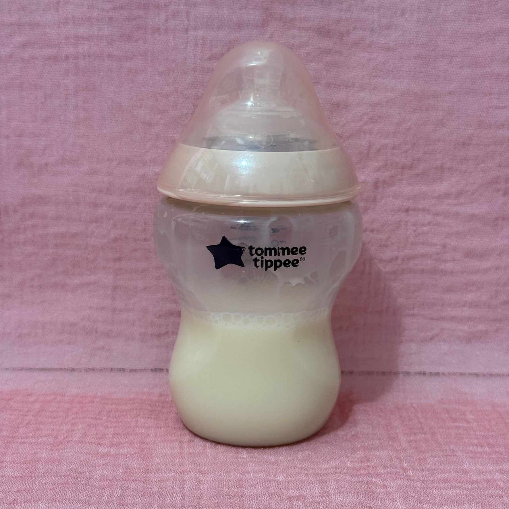 Baby bottle with Tommee Tippee logo in pink