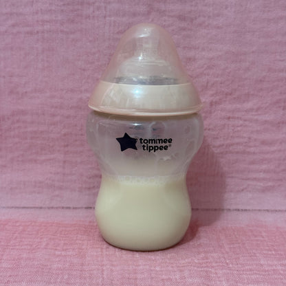 Baby bottle with Tommee Tippee logo in pink