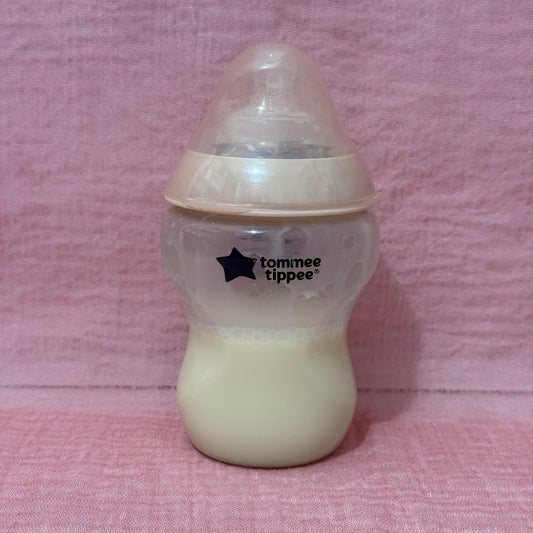 Baby bottle with Tommee Tippee logo in pink